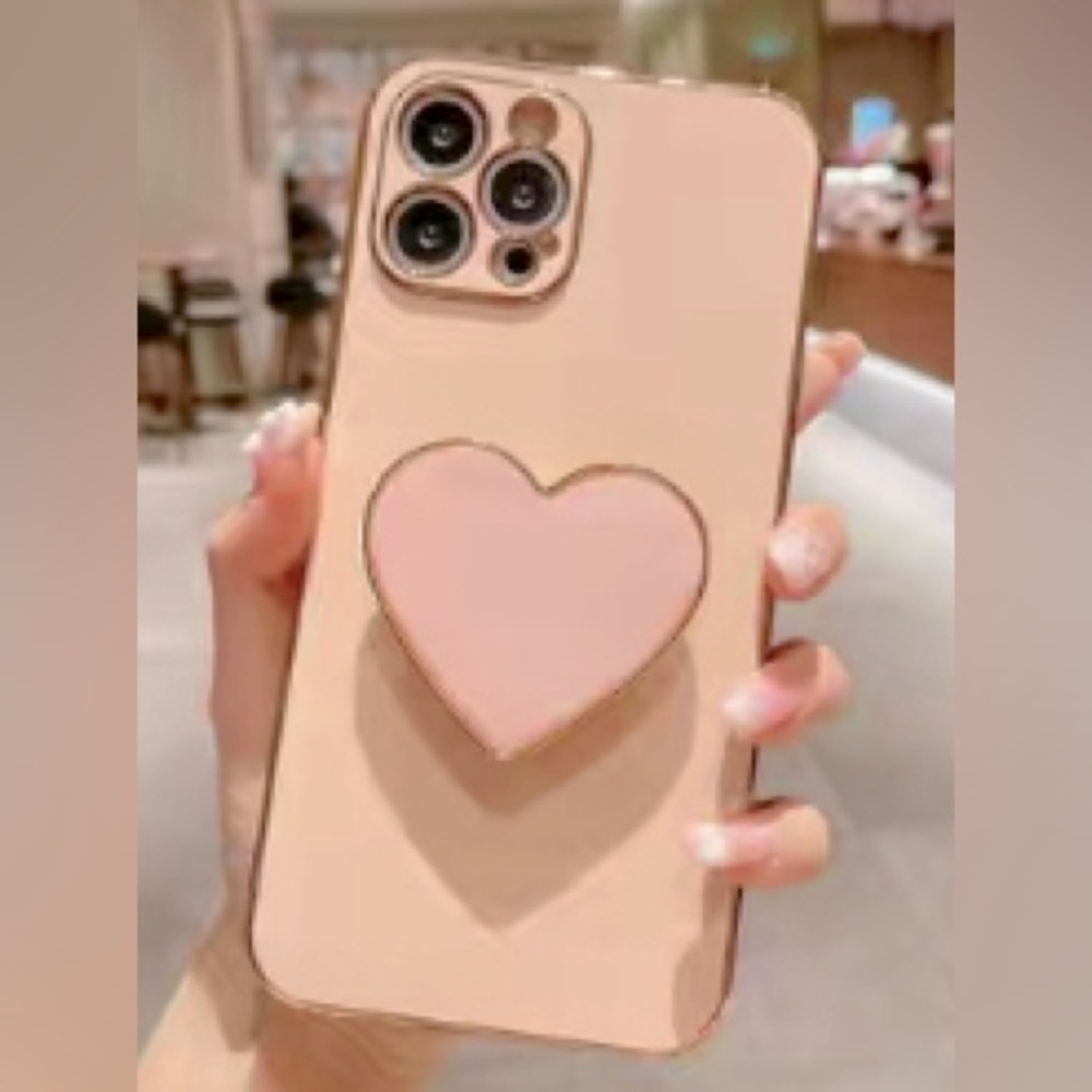 Pink/peachy color iPhone 13 case w/ matching, heart-shaped, pock socket. New!